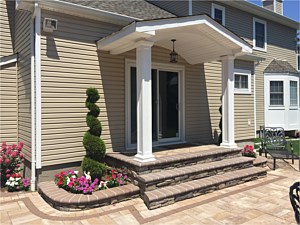 flared stoop cultured stone boral bucks county southern ledgestone sahara chestnut patio bullnose veneer 2 planters on sides portico square columns